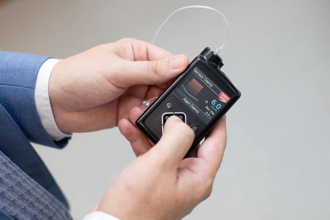 Hands operating a medical device